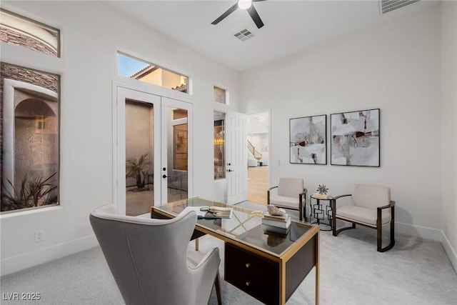 interior space with carpet, french doors, visible vents, and ceiling fan