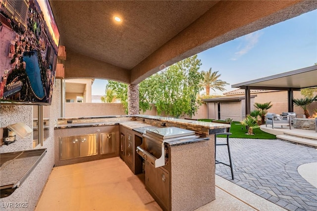 view of patio featuring area for grilling and fence