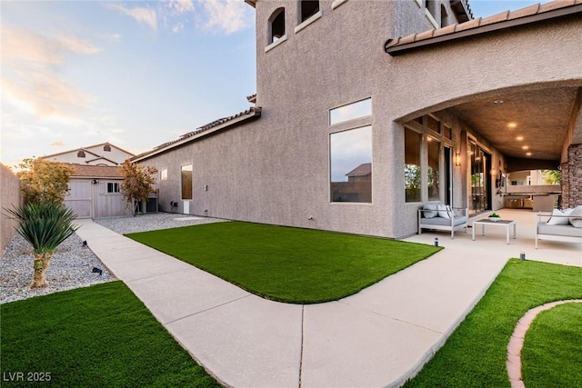 view of yard featuring a patio area, cooling unit, and an outbuilding