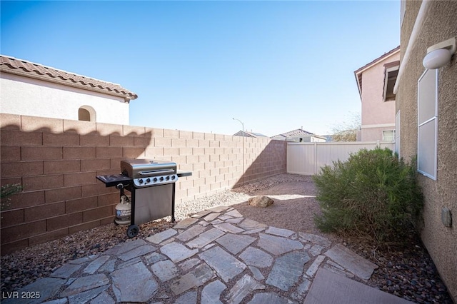 view of patio / terrace featuring a fenced backyard and a grill