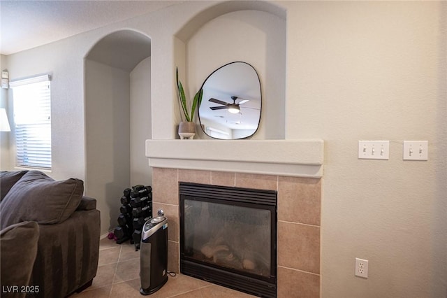 interior details with a tile fireplace