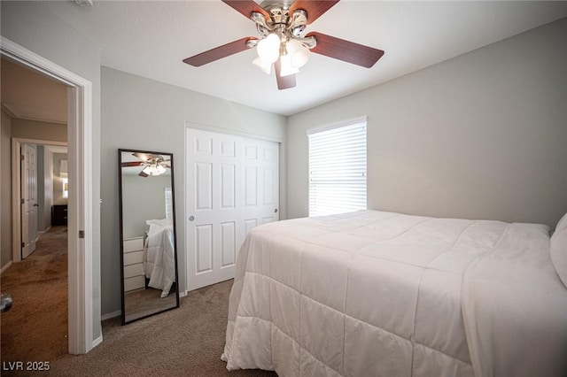 carpeted bedroom with a closet and ceiling fan