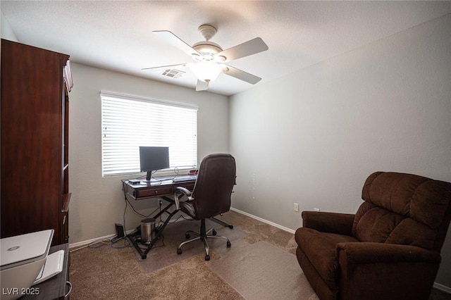 office space featuring carpet floors, baseboards, visible vents, and ceiling fan