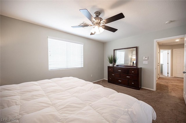 carpeted bedroom featuring ceiling fan and baseboards