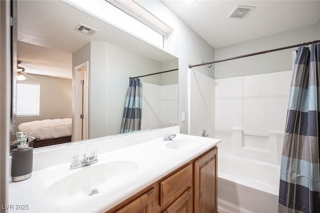 ensuite bathroom with visible vents, a sink, and shower / tub combo with curtain