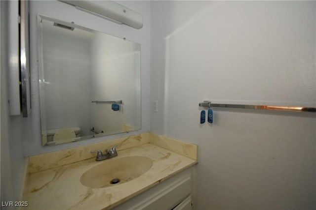 half bathroom featuring visible vents and vanity