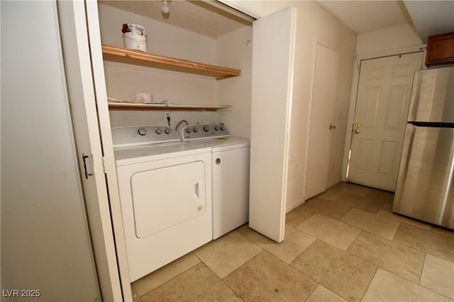 washroom featuring laundry area and washing machine and clothes dryer