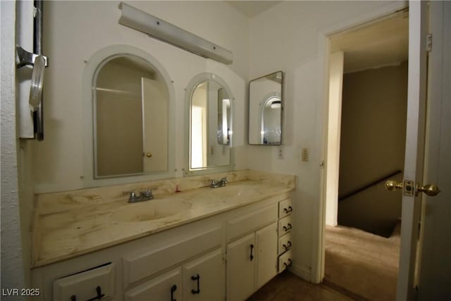 full bathroom featuring double vanity and a sink