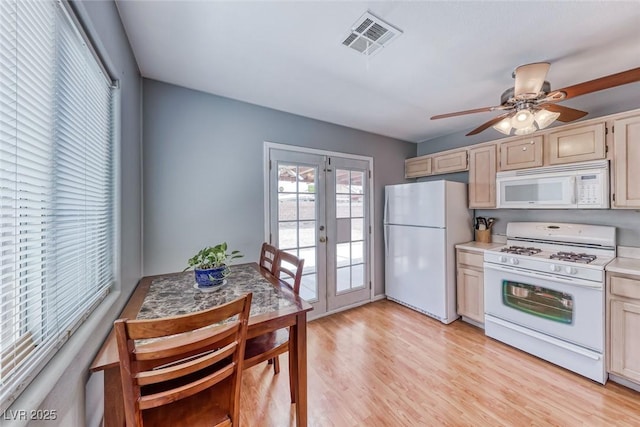 kitchen featuring white appliances, light wood finished floors, visible vents, ceiling fan, and french doors