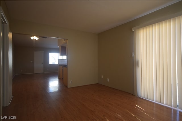 spare room with a ceiling fan and wood finished floors