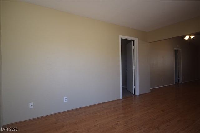 unfurnished room with wood finished floors