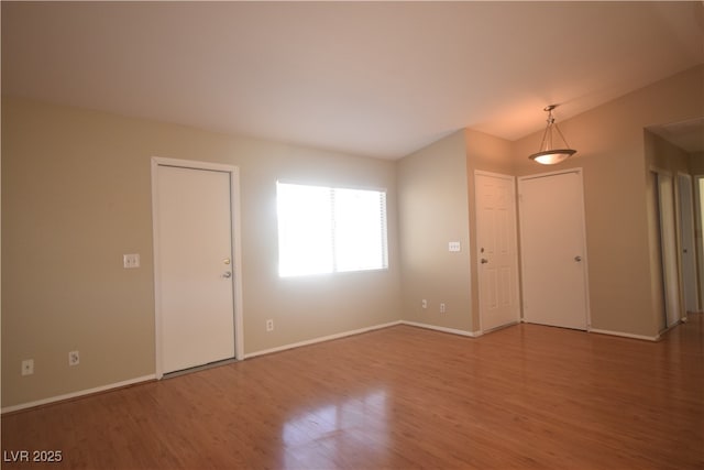 entryway with baseboards and wood finished floors