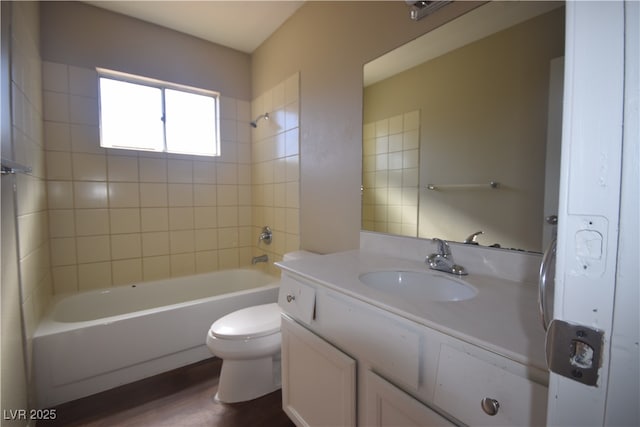 full bath with wood finished floors, bathing tub / shower combination, toilet, and vanity