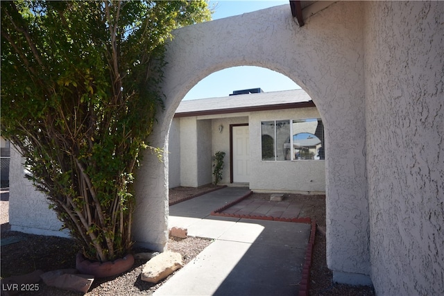 property entrance featuring stucco siding