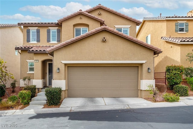 view of front facade with a garage, concrete driveway, a tile roof, and stucco siding