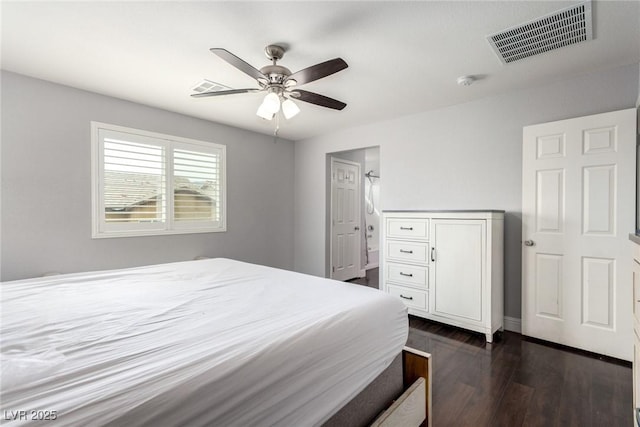 bedroom with a ceiling fan, visible vents, and dark wood finished floors