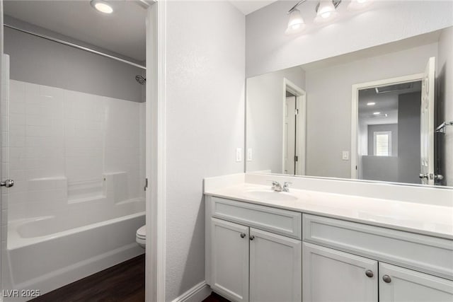 bathroom featuring bathing tub / shower combination, recessed lighting, toilet, vanity, and wood finished floors