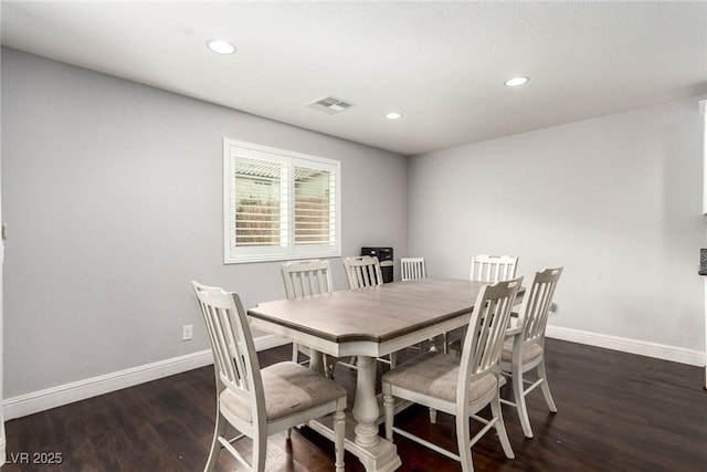 dining space featuring baseboards, visible vents, wood finished floors, and recessed lighting