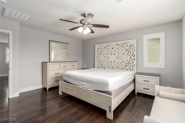 bedroom with visible vents, dark wood finished floors, baseboards, and ceiling fan