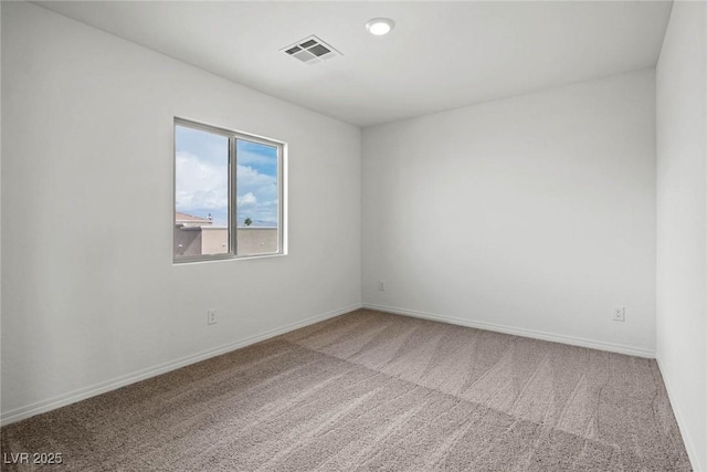 carpeted empty room with baseboards and visible vents