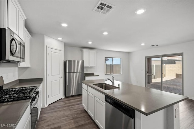 kitchen featuring appliances with stainless steel finishes, dark wood finished floors, visible vents, and a sink