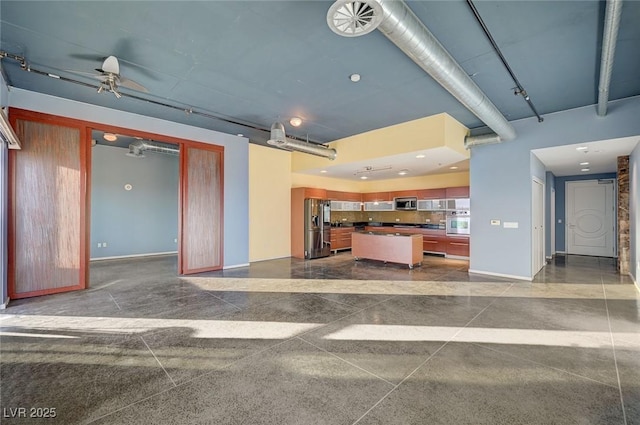 kitchen featuring stainless steel appliances, baseboards, and dark countertops