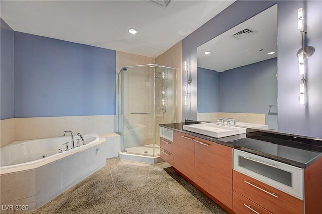 bathroom featuring visible vents, vanity, a bath, and a shower stall