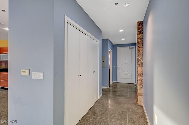 hallway featuring recessed lighting and baseboards