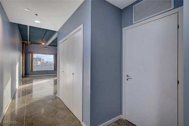 hallway with visible vents and baseboards