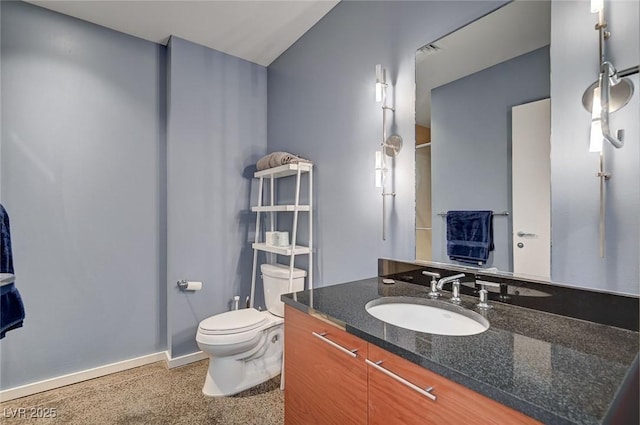 bathroom featuring baseboards, toilet, and vanity