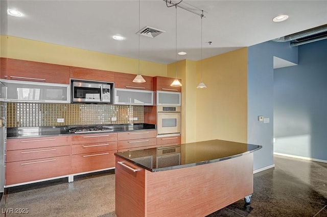 kitchen featuring visible vents, dark speckled floor, appliances with stainless steel finishes, modern cabinets, and tasteful backsplash