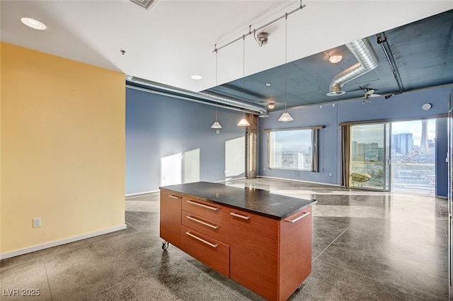 kitchen featuring dark countertops, modern cabinets, open floor plan, and baseboards