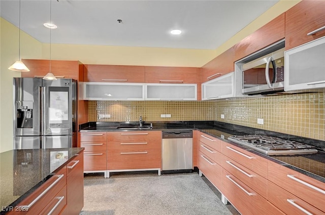 kitchen with decorative light fixtures, stainless steel appliances, modern cabinets, and a sink