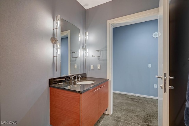 bathroom featuring baseboards and vanity