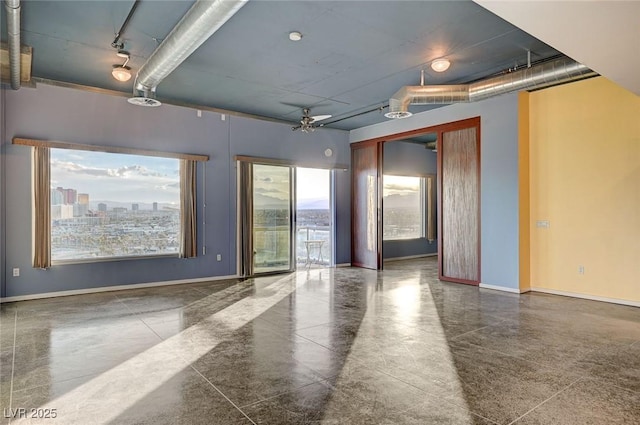 empty room with baseboards and a view of city