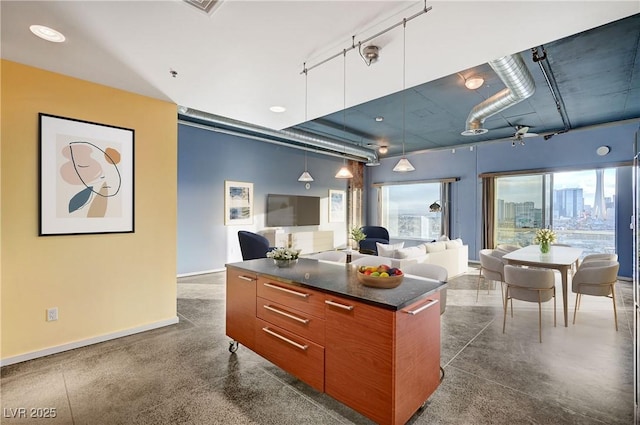 kitchen featuring dark countertops, modern cabinets, and open floor plan