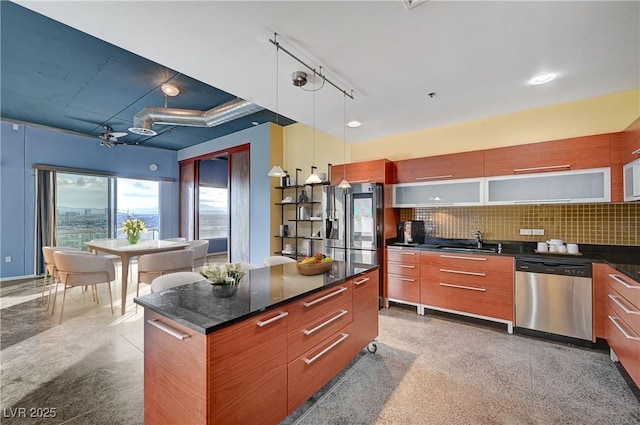 kitchen featuring decorative backsplash, appliances with stainless steel finishes, modern cabinets, and a sink