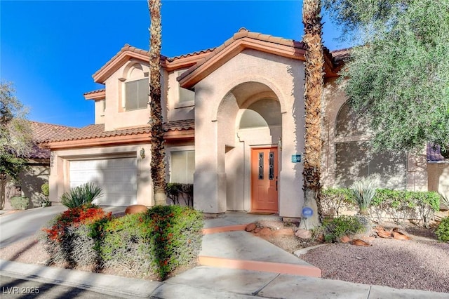 exterior space with stucco siding, a garage, concrete driveway, and a tiled roof