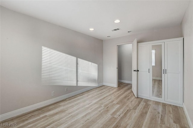 unfurnished bedroom featuring recessed lighting, visible vents, baseboards, and light wood-style floors