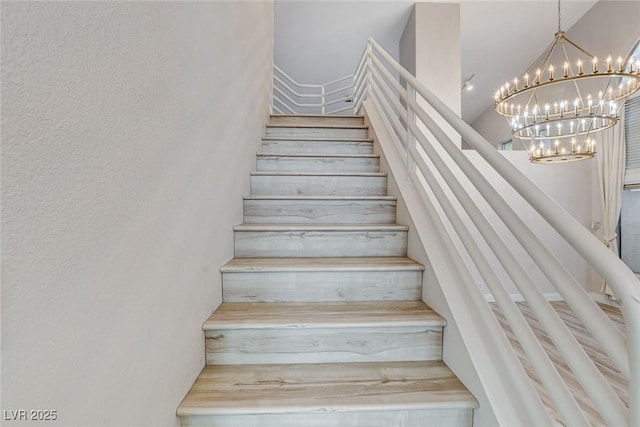 stairway with a chandelier