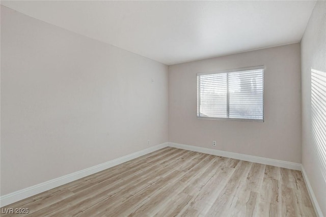 unfurnished room featuring light wood-style floors and baseboards