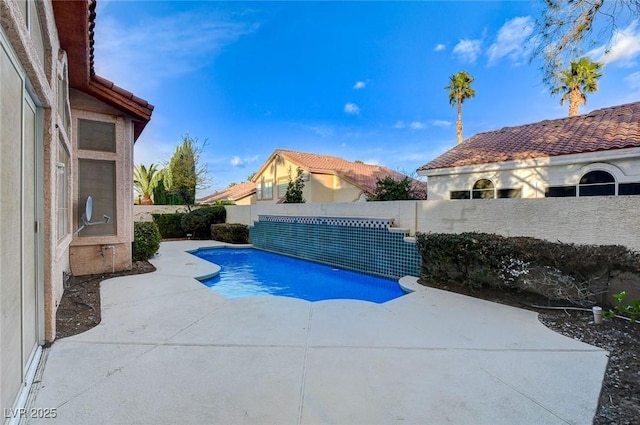 view of pool with a patio and a fenced backyard