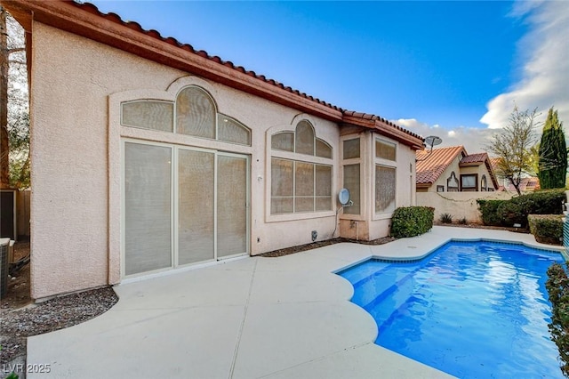 view of swimming pool with a fenced in pool, a patio, and fence