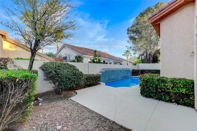 view of pool featuring a fenced backyard and a patio area