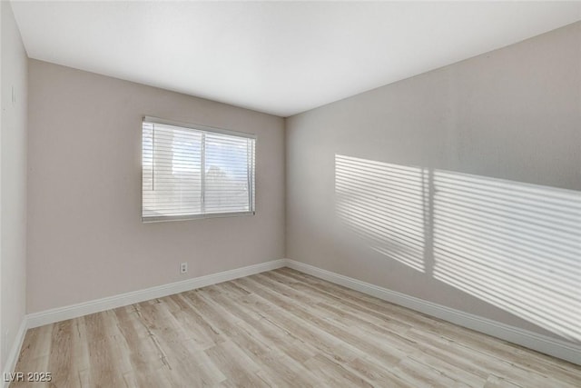 unfurnished room featuring light wood-style floors and baseboards