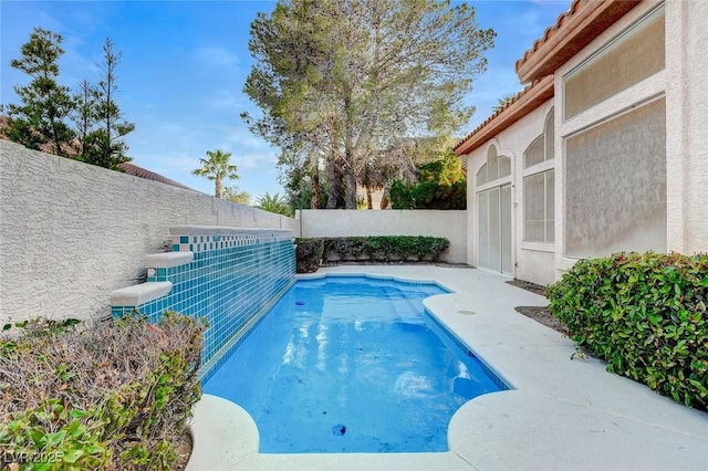 view of swimming pool featuring a fenced backyard and a fenced in pool