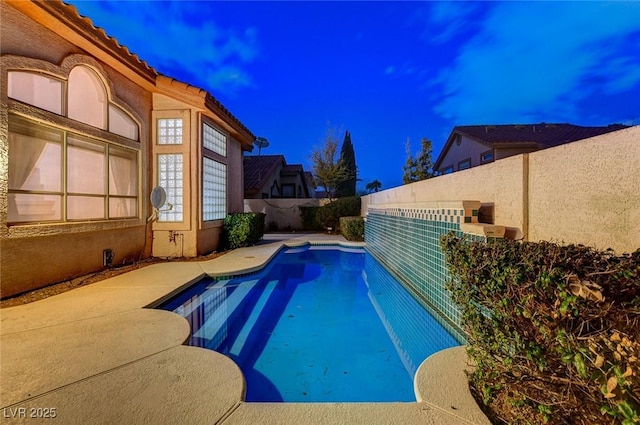 view of pool with a fenced backyard