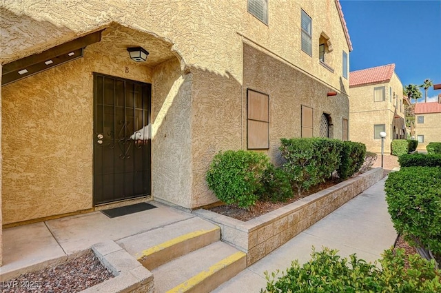 property entrance featuring stucco siding