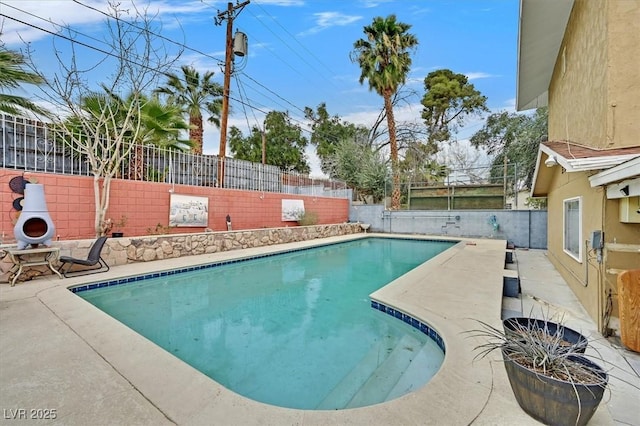 view of swimming pool with a patio, a fenced backyard, and a fenced in pool