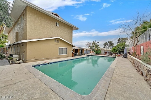 view of swimming pool with fence, a fenced in pool, and a patio